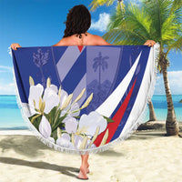 Round blue beach blanket with tassel fringe, red and white star emblem, floral border