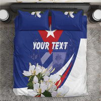 Top view of blue and white duvet cover with red star, 'YOUR TEXT', and flower print