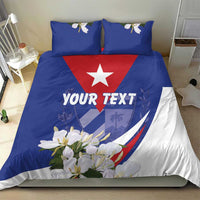 Blue duvet cover with red star, 'YOUR TEXT' lettering, and white flower accents