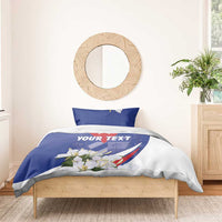 Blue duvet cover with red star and 'YOUR TEXT' across white floral print