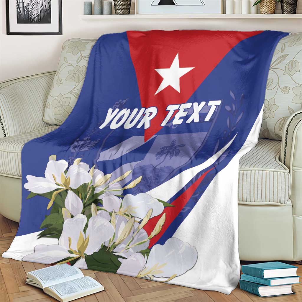 Blue star floral personalized blanket with 'YOUR TEXT', draped over couch arm.