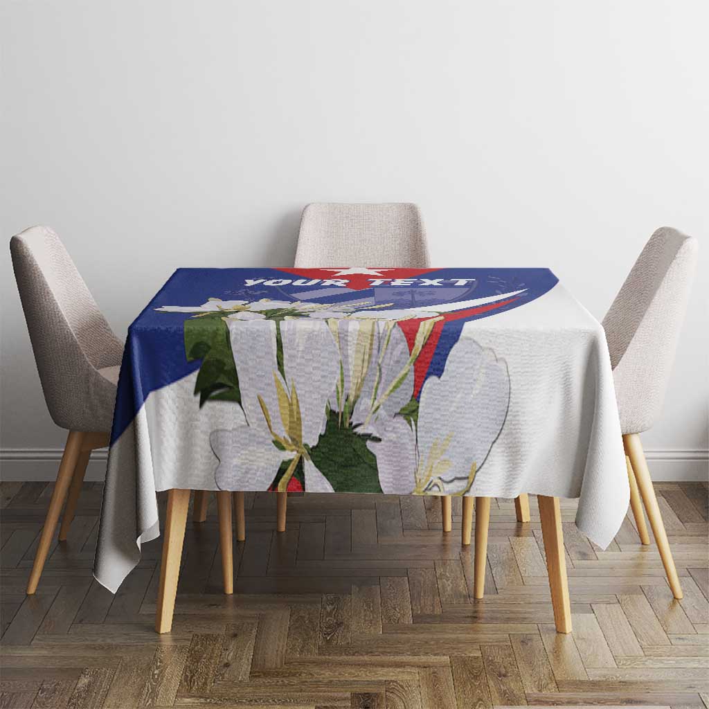 Blue patterned tablecloth on a dining table with chair backs visible
