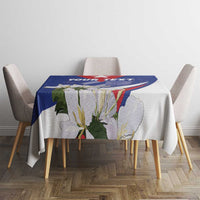 Blue patterned tablecloth on a dining table with chair backs visible