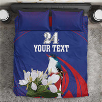 Blue bedding set: duvet and two pillowcases with bird, white flowers, and “24 YOUR TEXT”