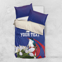 Blue bedding set with duvet and two pillowcases featuring bird, white flowers, “YOUR TEXT”
