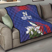 Blue quilt throw on sofa with red curved stripe, bird and white flower motif, custom text