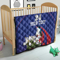 Blue quilt on wooden crib with red arch stripe, bird and white flowers, custom text