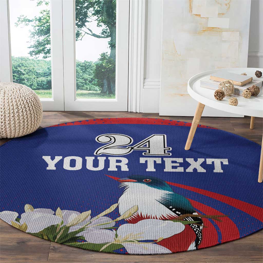 Round blue circular rug with "24 YOUR TEXT" toucan art, red swirl stripe, and white flowers
