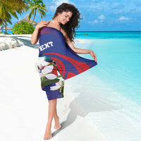Blue sarong with red swirl and bird/white flower print, partial 'TEXT' on center