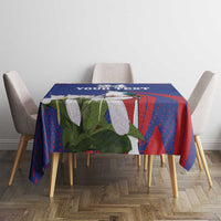 Blue tablecloth with red pattern and white bird, square table setup with four chairs
