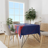 Blue tablecloth over dining table, red geometric accents and white bird floral print