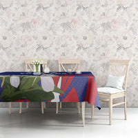 Blue tablecloth with red and green bird-and-flower design, laid on long console table