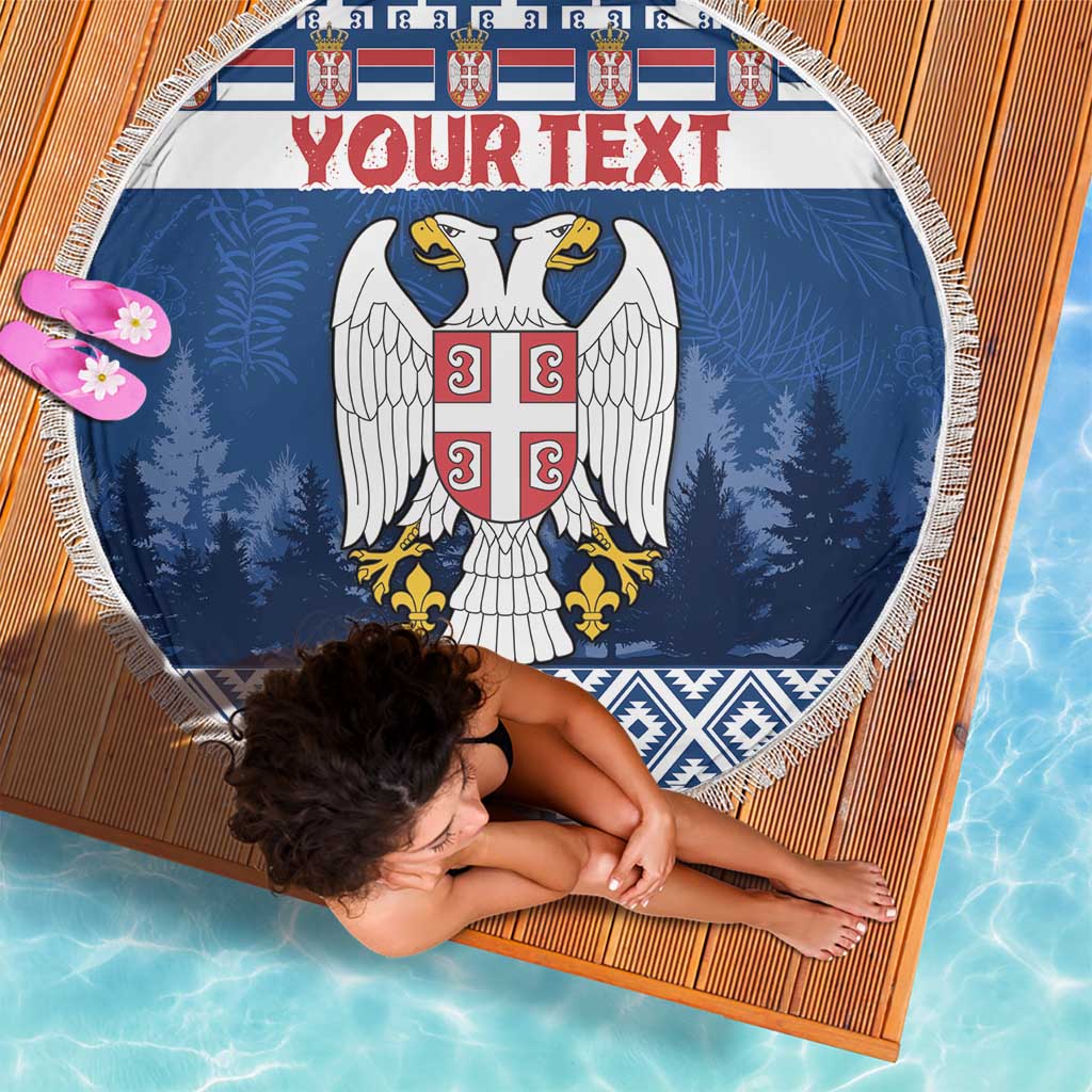Round blue beach blanket with fringe, eagle crest and 'Your text' over blue trees