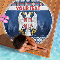 Round blue beach blanket with fringe, eagle crest and 'Your text' over blue trees
