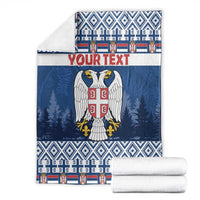 Blue Christmas blanket with eagle coat of arms, "YOUR TEXT", paired with rolled white linens