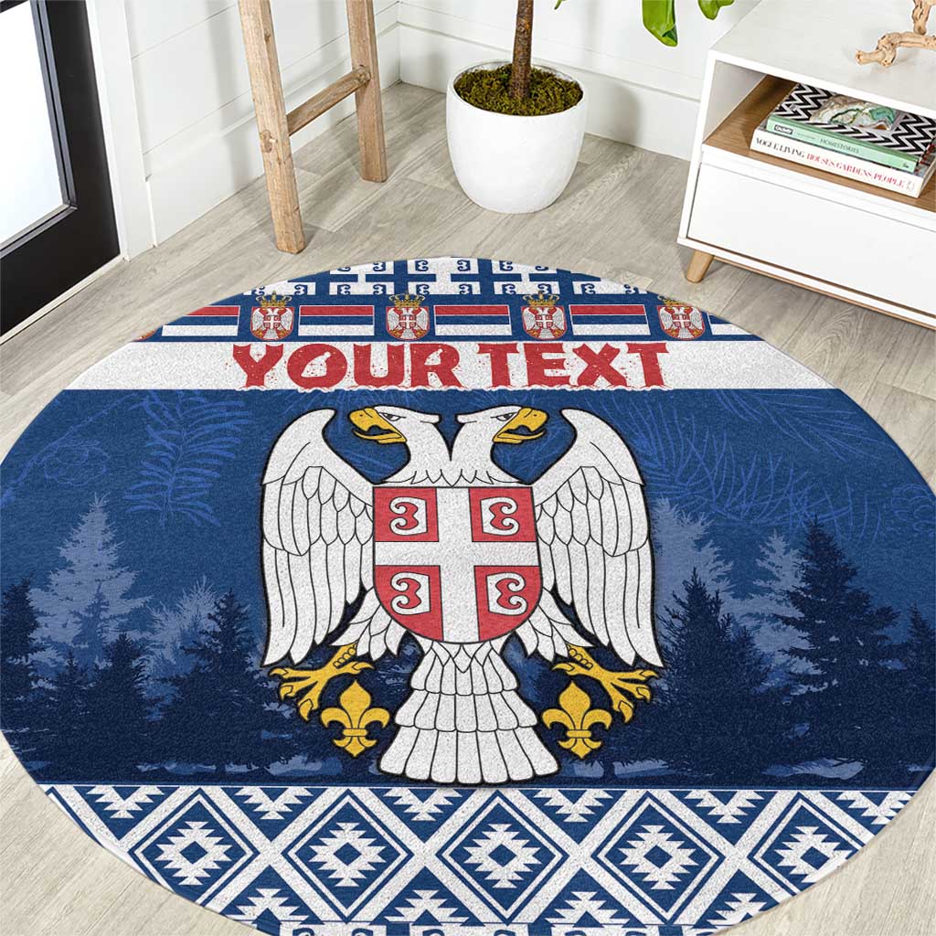 Blue round coat of arms Christmas area rug, pine tree and geometric border pattern