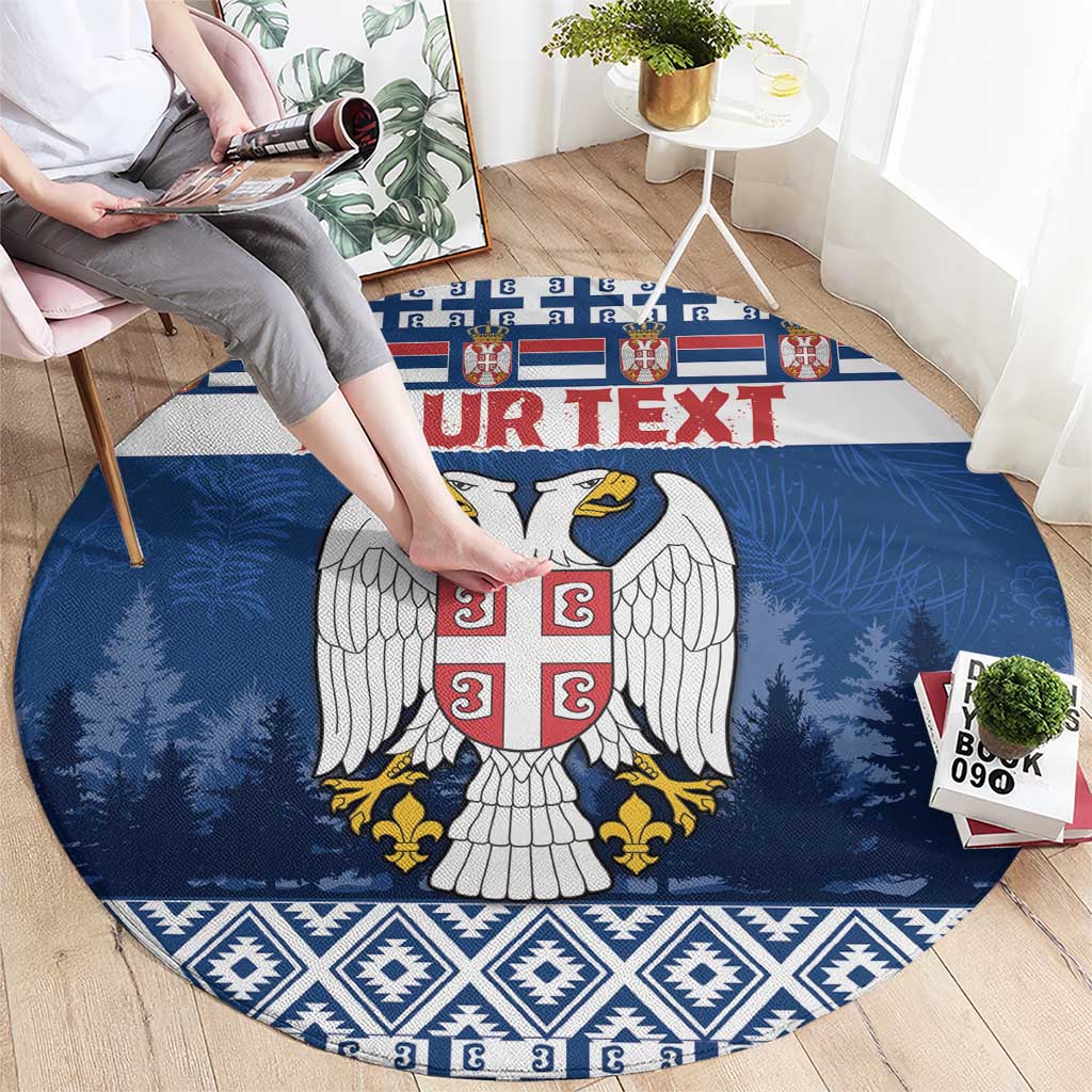 Blue round coat of arms rug with red shield, white wings, pine trees and border
