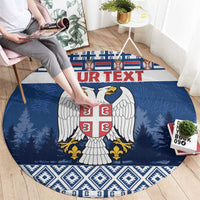Blue round coat of arms rug with red shield, white wings, pine trees and border