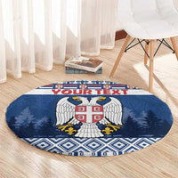 Blue round coat of arms rug with red shield crest, pine trees, and geometric edge