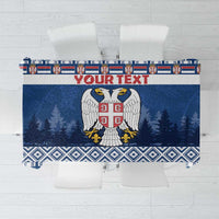 Blue personalized Serbia tablecloth with coat of arms, winter trees, and patterned border.