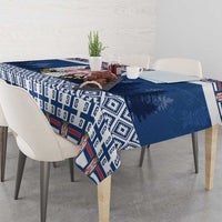 Blue Serbia themed tablecloth draped over dining table with patterned side panel.