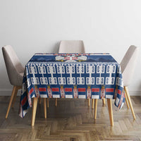 Blue Serbia coat of arms tablecloth on dining table with patterned top and sides.