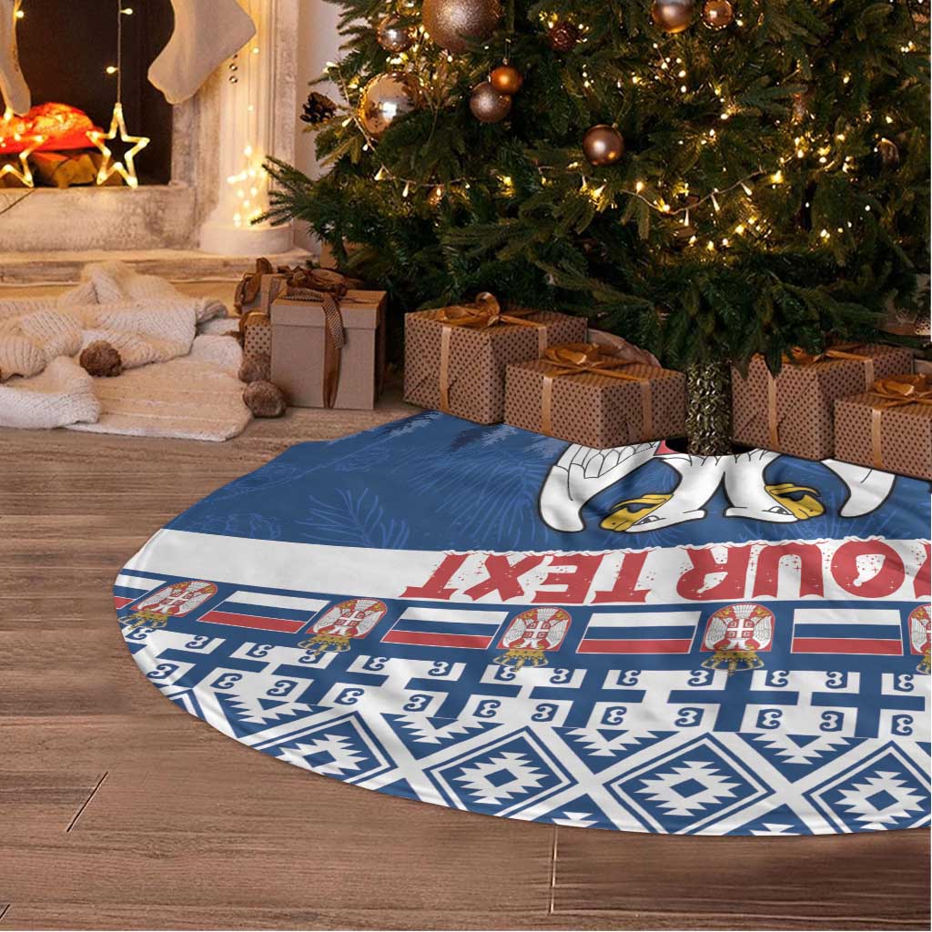 Blue patterned Christmas tree skirt with Serbia coat of arms, laid on the floor
