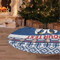 Blue patterned Christmas tree skirt with Serbia coat of arms, laid on the floor