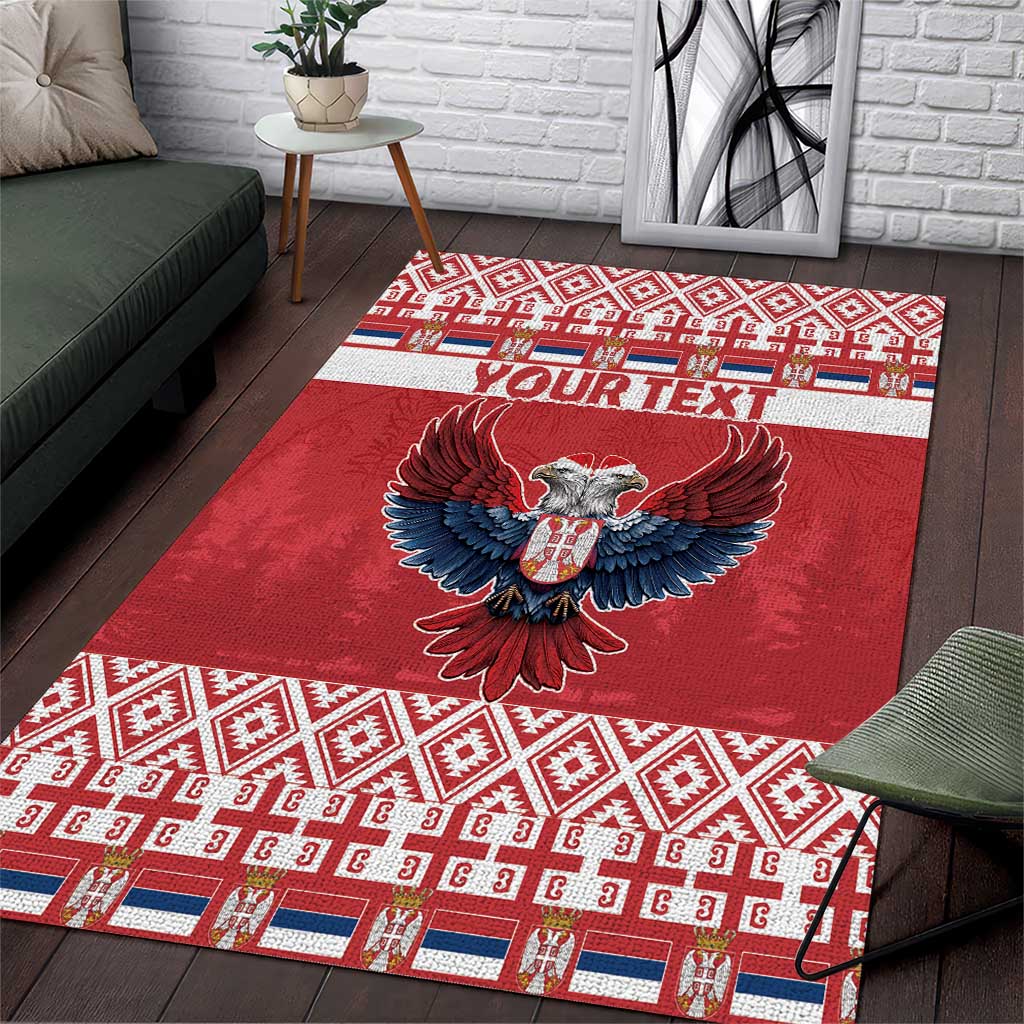 Red area rug with double-headed eagle, geometric border, and "YOUR TEXT" band