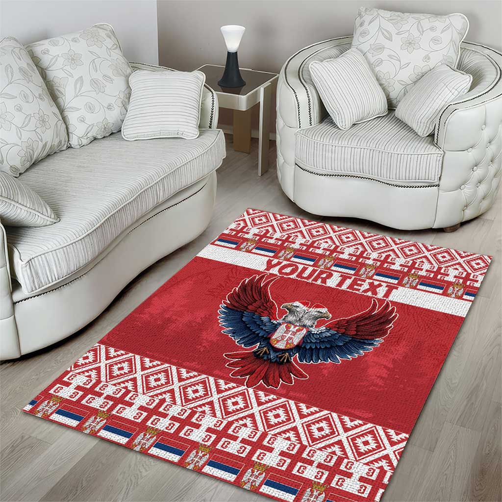 Red area rug with double-headed eagle design, geometric trim, and "YOUR TEXT"
