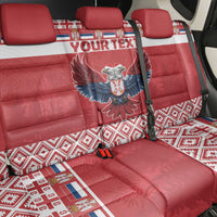Red back car seat cover with winged emblem and patterned footwell mats