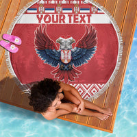 Red round beach blanket with fringe edge showing double-headed eagle and “YOUR TEXT”