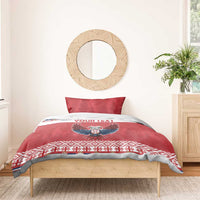 Red bedding set on wooden bed frame with eagle emblem, “YOUR TEXT” stripe, and festive border