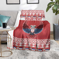 Red personalized Christmas blanket with double-headed eagle and your text, draped on sofa