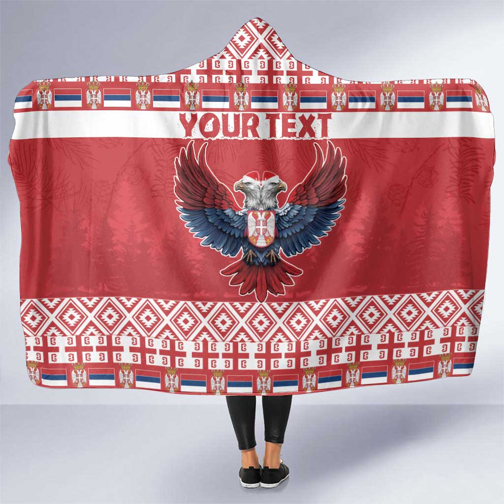 Red hooded blanket with eagle emblem and Serbian-style pattern border, wrap front