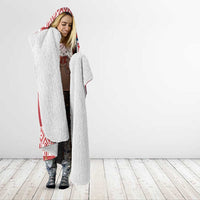 Red and white hooded blanket with sherpa texture and patterned trim, standing