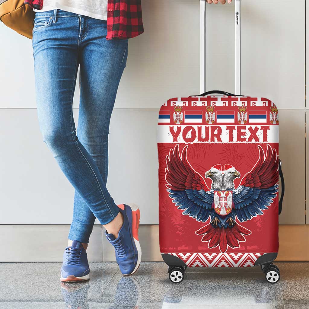 Red wheeled luggage cover with double-headed eagle graphic and 'YOUR TEXT' panel