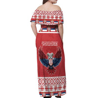 Women's red off-shoulder maxi dress back view with central eagle and holiday border print