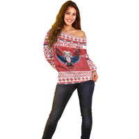 Red off-shoulder Christmas sweater with eagle graphic and all-over festive pattern