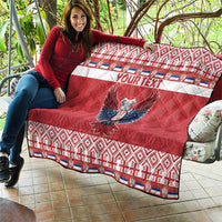 Red quilt on patio with 'YOUR TEXT' and double-headed eagle, quilted geometric trim