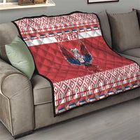 Red eagle quilt on sofa with 'YOUR TEXT', blue wings emblem, geometric border trim