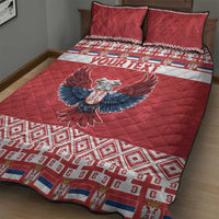Red quilt bed set on bed with eagle center graphic and geometric corner border