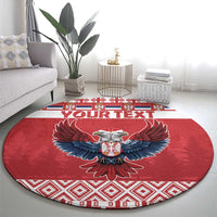 Red round carpet rug with central double-headed eagle, blue wings, and red/white border