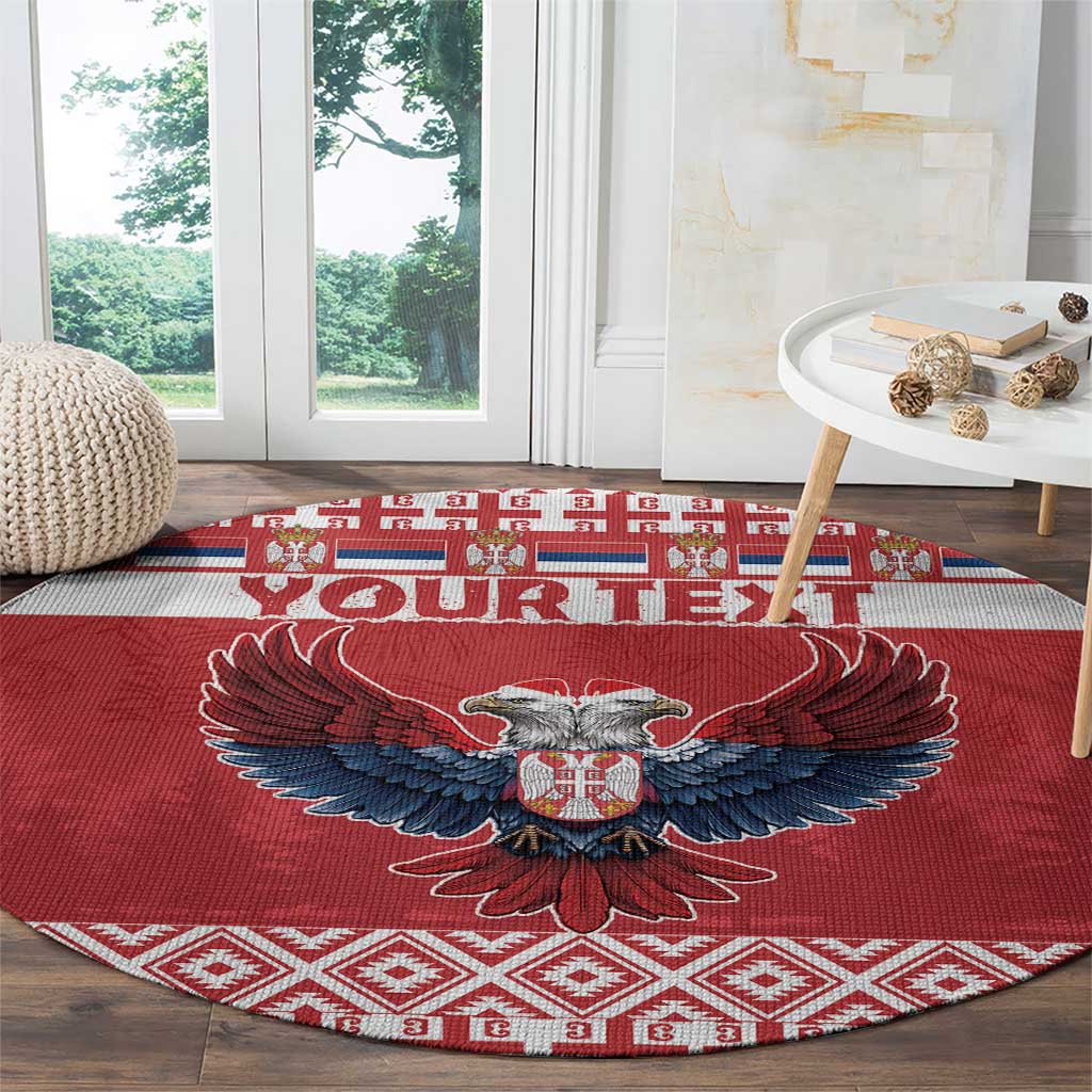 Red round carpet rug featuring double-headed eagle emblem over diamond pattern border