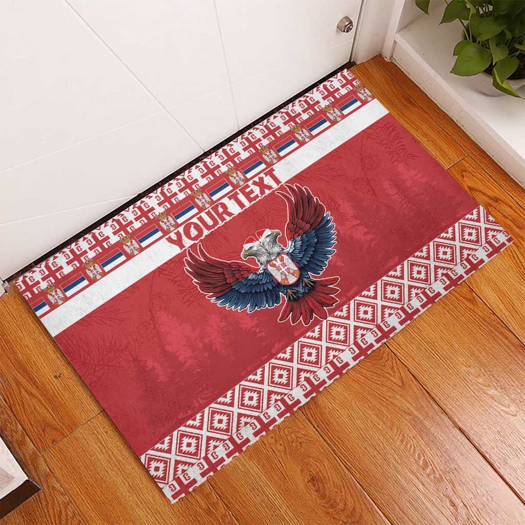 Red rubber doormat with custom text, eagle emblem, and patterned border along edges