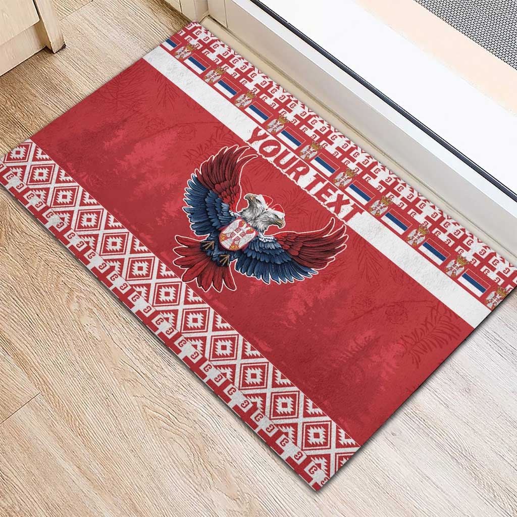 Red rubber doormat featuring eagle emblem and custom text with geometric border strips