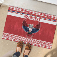 Red rubber doormat with eagle emblem and custom text, surrounded by patterned ribbon border