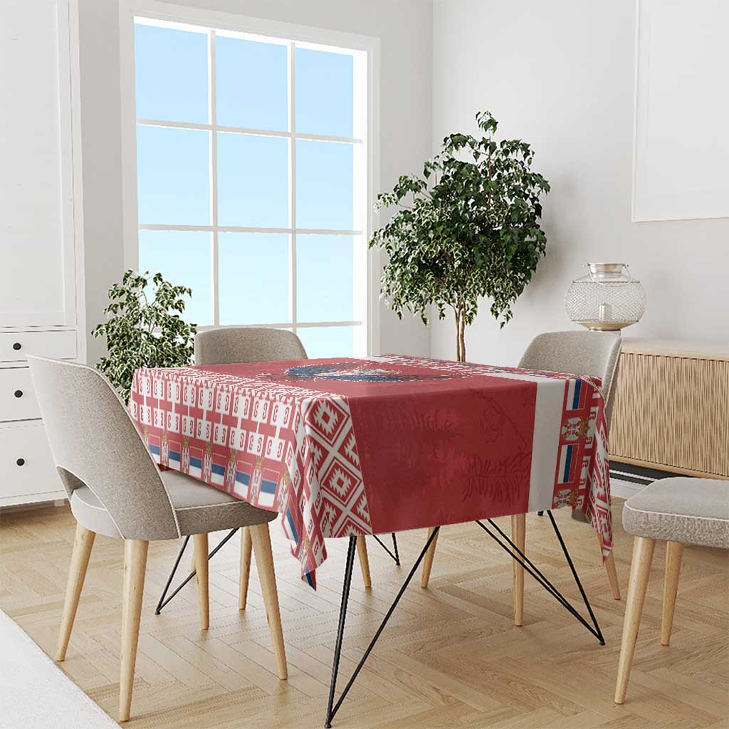 Red and white patterned Christmas tablecloth on dining table with festive border