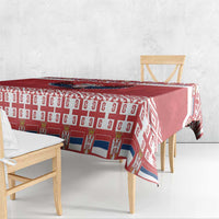 Red Christmas tablecloth draped on table with repeating geometric pattern