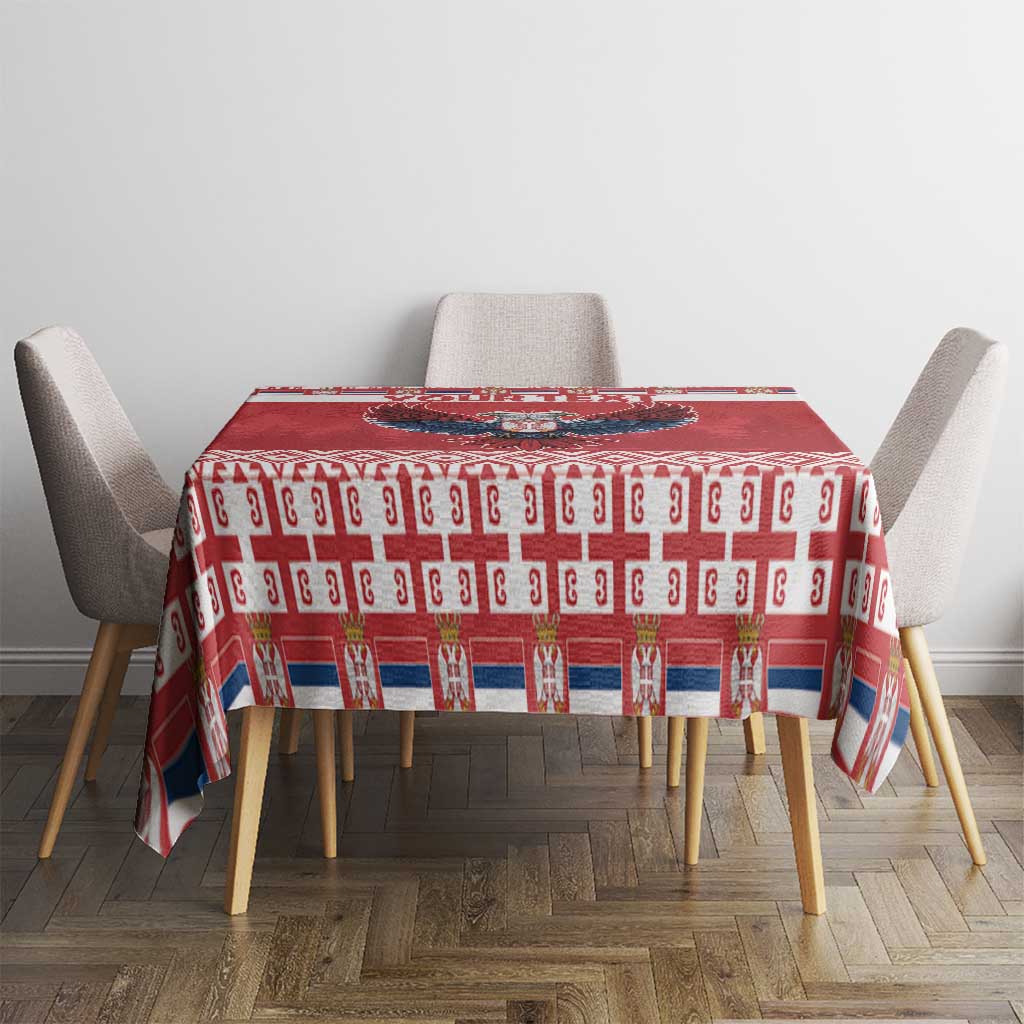 Red Christmas tablecloth with repeating icons and white geometric stripe border
